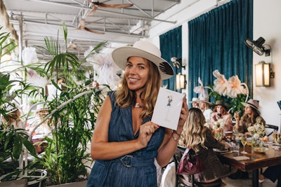 Artist Gissi Jimenez sketched each guest onto a postcard keepsake and painted guests’ names on their gifted hats.