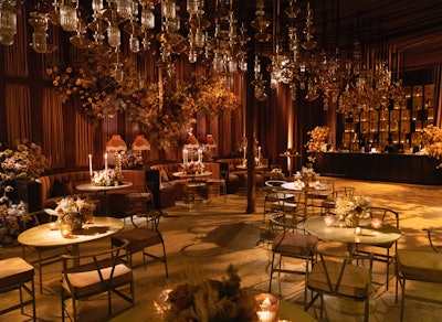 In the main event space, copper and blush draping set the stage for a bistro-inspired design featuring more than 100 Pasadena Collection glass pendant lamps, a grazing table by Lucky Graze, desserts by Salted Butter Company, and a custom 16-foot midcentury mahogany bar. Arrvo Coffee provided an espresso and tea bar, while passed appetizers and a sushi station by Untitled Events rounded out the culinary offerings.
