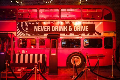 The venue's patio features a double-decker bus; the event team branded it and added a 'Never drink & drive' sign.