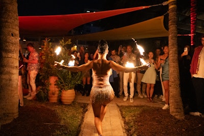 A fire dancer added an illuminated element to the beachside event.