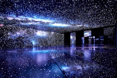 To mimic the night sky, the installation features LED projections on the walls, ceiling, and floor that fill the space with constellations and bursts of starlight.