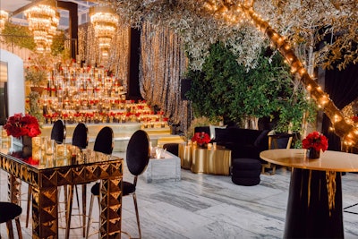 Nothing conveys a sense of warmth quite like candles—an idea that Warner Bros. effectively leaned into with its 2023 Oscars event. The glamorous gathering had an over-the-top event design from JOWY Productions, which leaned into a mix of black and gold with accents of red—and plenty of sparkle. Over 300 glass hurricane candles filled with black sand flickered throughout the party, juxtaposed with twinkle lights in the trees. As a focal point, a tiered candle installation featured 5-foot crystal and gold chandeliers. See more: Oscars 2023: Elegant Event Inspiration From Hollywood's Most Glamorous Week