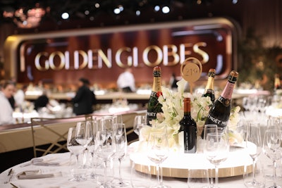 The ballroom's centerpieces featured simple white flowers surrounded by bottles of Moët & Chandon, the Golden Globes' official Champagne. The brand also continued its long-standing philanthropic 'Toast for a Cause' initiative in partnership with Entertainment Tonight, which allows celebrities on the red carpet to give back to a charity of their choice by toasting with Moët Minis; the brand donates $1,000 to the charity for each toast. This year's red carpet also featured a Moët & Chandon vending machine, which was wrapped in red and filled with Moët Minis.