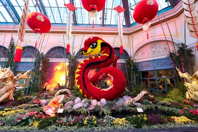 In the North Bed, a 28-foot floral serpent honors the Year of the Snake. Red and gold silk lanterns hang above, while a koi fish fountain spouts water into a tranquil pond.