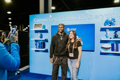 Fans could participate in meet-and-greets with college football greats like former Notre Dame quarterback Brady Quinn, Ohio State University wide receiver Cris Carter, and Colorado Buffaloes stars Shedeur and Shilo Sanders (pictured with fan). AT&T customers enjoyed VIP access through the dedicated Fast Pass lane for meet-and-greets.