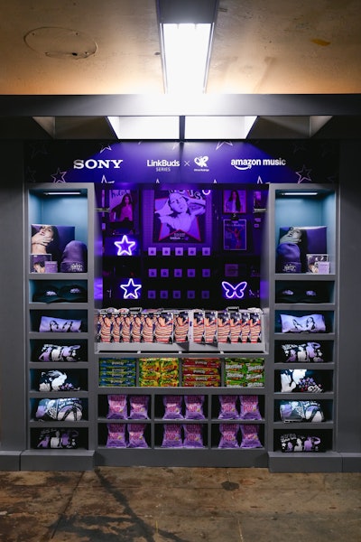 An on-site merch stand inspired by old-school subway newsstands offered T-shirts, beanies, CDs, snacks, and more.