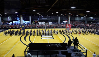 At the center of Playoff Fan Central was a gold-hued football field where marching bands and cheerleading squads from both teams performed.