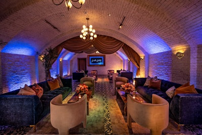 'For decor, we amped up their existing natural elements folding in marble, stone, woods, leather, and velvet,' Mazzuca said. 'We juxtaposed the venue's warm marigold banquettes and honey brown wood with a deep rich navy, paired with mauve, aqua, and moss accents and patterns, giving the space a sophisticated, but unexpected, look and feel that felt simultaneously chic yet cozy.' Rentals were provided by Bespoke Bohéme, Found Rental Co., and FormDecor, while Town & Country Event Rentals and Jimmy's Permit Service provided additional production logistics.