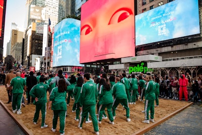 In October, the brand kicked off its partnership with a massive Times Square takeover. The experience began with the Recruiter, flanked by Pink Guards, engaging fans. Then, dozens of Squid Game players participated in a challenge in a giant sand pit. Adult fans were invited to join Johnnie Walker at various happy hours around the city where they could enjoy show-inspired cocktails.