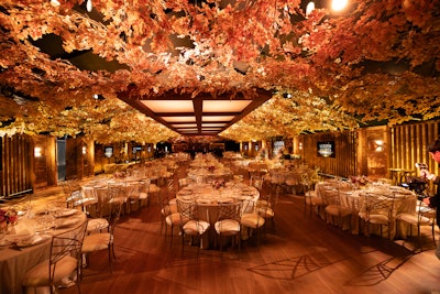 Guests at the viewing party enjoyed a seated meal under a canopy of lush leaves.