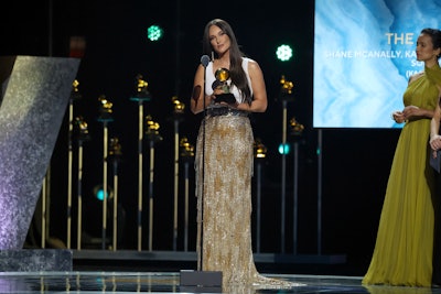 During the Premiere Ceremony, Kacey Musgraves accepted the award for Best Country Song for 'The Architect.' The event, which was streamed live on The Recording Academy’s YouTube channel and website, was produced by Branden Chapman, Ruby Marchand, Lindsay Saunders Carl, and Rex Supa on behalf of The Recording Academy. Greg V. Fera was the executive producer, and Cheche Alara was the music producer and music director.