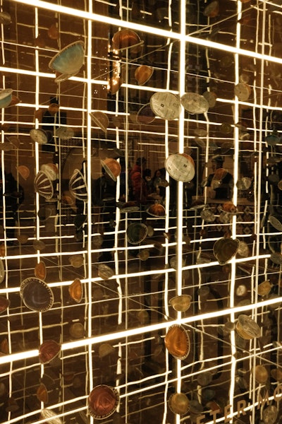 Various display areas, like this infinity room-inspired space, showcased Nespresso capsules as treasures or jewels.