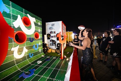 In a fun activation from True Religion Brand Jeans, fans who made two out of four football tosses won True Religion swag.