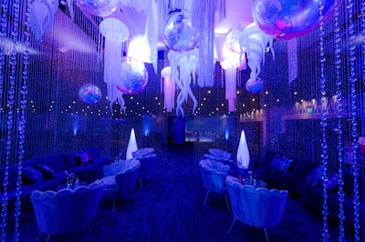 For Atlanta Pride's 2023 kickoff event, organizers wanted to make a splash. Designed by YES Event Designs, the gathering at the Georgia Aquarium immersed guests in a vibrant, fantasy-like environment that offered a futuristic take on an under-the-sea theme. While under-the-sea themes have long been popular, the team drew inspiration from unexpected places, like scenes from the Avatar movie and the ocean's bioluminescence. In a lounge area, crystal curtains were meant to look like ocean water; overhead were iridescent bubble orbs, eye-catching crystals that caught light like a silver jack fish, and custom wave drapes to mimic the sea and illuminate an ever-changing jellyfish. See more: Check Out This Fresh Take on an Under-the-Sea Event Theme