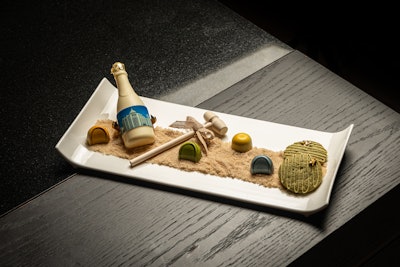 Guests at Loews Miami Beach Hotel enjoyed both welcome and turndown amenities, including this whimsical beach dessert scene with the hotel photo printed on a mini white chocolate Champagne bottle.