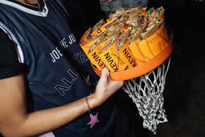 The event also featured branded basketball courts, an open-air photo booth, and on-theme serving trays with hanging basketball nets.