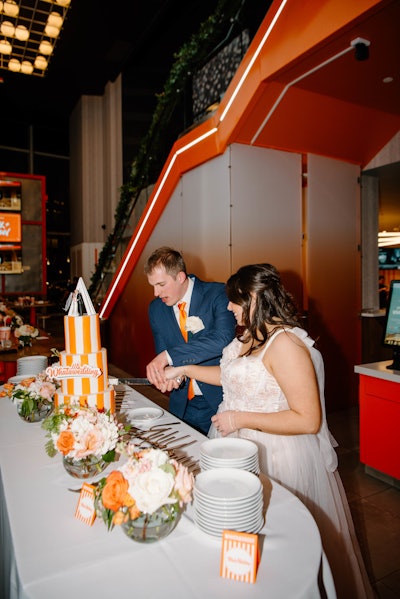 The event also featured custom Whataburger-inspired decor and an eye-catching striped wedding cake; there was also a vintage car and photo booth.