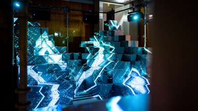 Pendulum recently worked with Burberry's Chicago store to help promote the fashion brand's Alpine collection. The team turned the retail setting into an artistic expression using minimalist materials like stainless steel, exposed wires, sleek fixturing, custom industrial fans, and these projection-mapped box structures to emulate the sensations of nature.