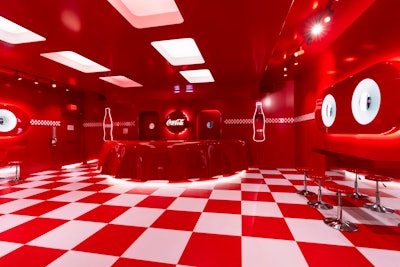 The main space gave guests a place to cool off and enjoy an ice-cold Coke or float; there was also a photo booth. Crown + Conquer worked with Firecracker Works on fabrication, Nitemind on lighting, MAS Media on audio, and 200 Proof for brand ambassadors.