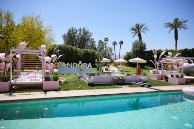 Outside, the expansive backyard set the stage for relaxation and brand immersion. Pandora pink tiles replaced the original outdoor flooring, while custom-fabricated daybeds, life-size charms, branded umbrellas, and towels and pool floats created the perfect lounging environment. The outdoor space also included a custom putting green, bocce ball, and pickleball courts. Guests enjoyed everything from poolside drinks and massages to yoga sessions, catered meals, and nightly s’mores.
