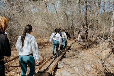 The second day started with a 90-minute 'desert bathing' experience inspired by the Japanese practice of forest bathing. Guests toted their branded water bottles and bandanas and wore gifts from brand partners, including leggings from Vuori.