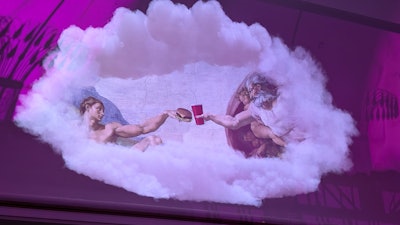 On the ceiling was projected a Sistine Chapel image featuring Adam reaching out for a hamburger.