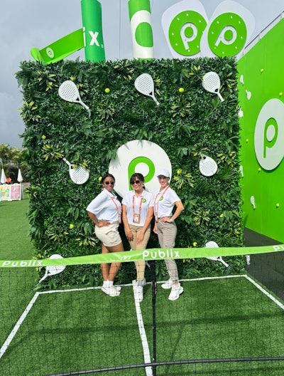 Publix Supermarkets partnered with Taylor Jean Marketing Agency on a 15-by-30-foot back wall and a 15-by-10-by-15-foot oversize reusable Publix bag, serving as both an immersive photo opportunity and a pop-up sampling station. The vibrant green structure, complete with oversize handles and branded elements, handed out free food samples—including Chicken Caesar Pinwheels—and premium branded giveaways.