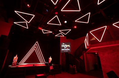 In early 2024, Doritos celebrated its new nacho cheese-flavored spirit, in partnership with Empirical, with a design-forward event presented by Eater. More than 300 guests were welcomed by glowing, red Doritos-like triangles, made from neon and LED lighting, which hung from the venue's ceiling. Vox Media worked with creative agency Mythical Creatures on the event's design and production. See more: This Stylish Launch Party Used Doritos as Decor (Yes, Really)