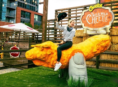 In 2023, Frito-Lay Canada hosted the “Wild Wild Cheetle,” a wild-bucking Cheetos bull for fans to ride in Calgary. Located within a Frito-Lay Bullpen, the giant mechanical “bull” let fans take a ride before enjoying cheekily named snacks including the “Cheetos Was His Nameo” hot dog, the “Ruffles Cruncharoo” sandwich, and the “Yippe Ki Lay’s” doughnuts. Frito-Lay Canada worked with creative agency Motive on the activation.