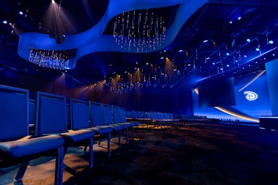 Seven massive custom chandeliers—one stretching 30 feet wide—hovered above a fully programmable lightscape of 600 kinetic fixtures, each on its own motorized hoist, synced with another 600 lights that wrapped around the space.