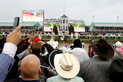 A crowd of 147,406 spectators gathered, down from last year’s attendance of 156,710, a decline that’s likely due to the rainstorms that rolled in throughout the day.