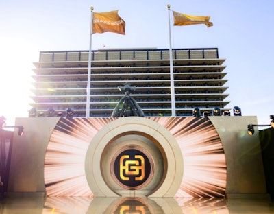 Guests arrived via a gold carpet staircase before exploring a series of interactive brand activations, including a 'GoldBot' photo moment in front of a Genesis GV80 coupe (a twist on the GlamBot with Cole Walliser), a character meet-and-greet with Pikachu, and a Maybelline photo setup. Hennessy offered a roaming cocktail cart with bottle engraving.