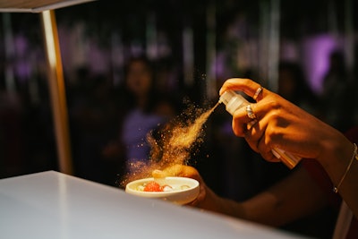 Guests were able to spray edible gold dust on teardrop cakes, reflecting the packaging of the brand's Repair Collection.