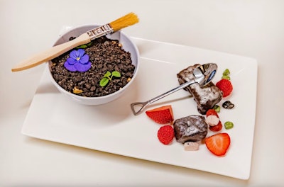 For a fundraiser at the Frost Science Museum in Miami in 2022, Constellation Culinary Group created a dinosaur-inspired menu with hidden “fossils” and grazing stations. The interactive dessert featured chocolate “fossils” nestled underneath gold dust. Guests were instructed to use the fossil brush to brush aside the dust and edible mini garden to discover a slew of sweet fossils and edible rocks. See more: This Catering Team Amped Up an Event Theme with a Clever Menu That Guests Really 'Dug'