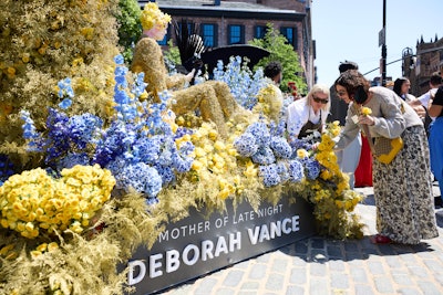 The event was designed as both a photo-friendly installation and an interactive fan experience. Guests could take photos with the sculptures and create their own complimentary bouquets by selecting flowers directly from the displays. The sculptures included storytelling-driven elements such as tropical palms and lotus flowers for Ratliff, fiery reds and blacks for Daenerys, and classic Italian botanicals for Carmela. Overall, Max gave out around 1,200 bouquets throughout the day.