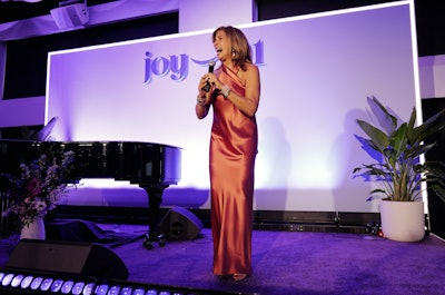 The event culminated in a stage presentation by Kotb, plus a special music performance by Rachel Platten. (The evening ended with Kotb joining Platten at the piano where the two sang “Fight Song” together with the crowd.) Mirrored Media built a custom LED-trimmed stage featuring the brand’s gradient, branding, and a custom lighting rig for the space.