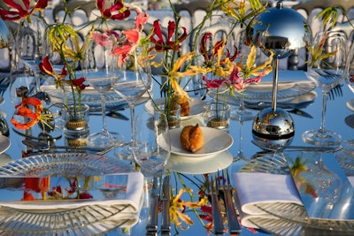 The glamorous dinner made an impression with colorful florals and simple, reflective table furnishings.
