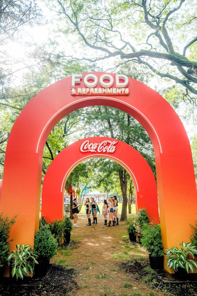 Fans entered through a custom Coca-Cola archway and explored menus branded “Presented by Coca-Cola” while enjoying complimentary samples of original Coke, Coke Zero, and Cherry Coke.