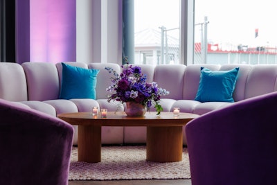 Inside the marina-side venue, the event featured curated food, drinks, custom florals matching the color gradients, a live DJ, and screens that displayed custom content introducing guests to the app, its advisors, and content. Bay windows looked out over the Hudson River sunset, consistent with the app’s branding. Guests could also enjoy a unique photo moment rooted in joy, where they threw confetti and received a fun moving GIF of the confetti falling around them.