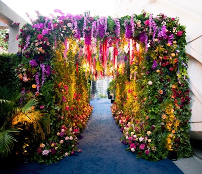 This dreamy, museum-inspired floral tunnel was created for Disney's 2022 Emmys party, where 'modern botanic brilliance' was the theme. Sterling Engagements worked with ENSO Creative on the floral design and decor, which mixed jewel tones, botanical greens, and luxe blooms. See more: Emmys 2022: Inside Parties From Netflix, Disney, Paramount, and More