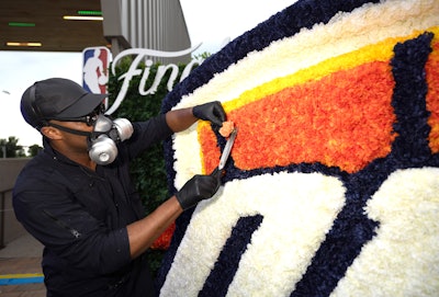 Mr. Flower Fantastic was pictured on site donning his signature all-black jumpsuit and respirator mask as he tended to the flowers.