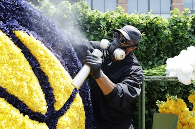 The enigmatic Mr. Flower Fantastic was the mastermind behind the floral structures, which replicated the logos of iconic NBA organizations using 10,000 florals.