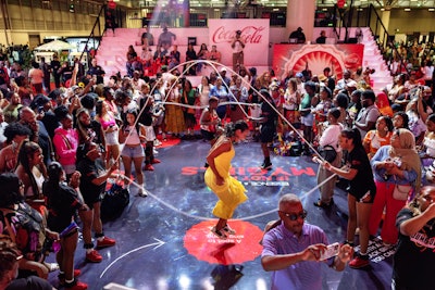 Coca-Cola's Essence Festival kickoff block party featured a custom charm station, photo ops, karaoke, and a double Dutch performance by GameOva Skip and Jump DC Superstars.