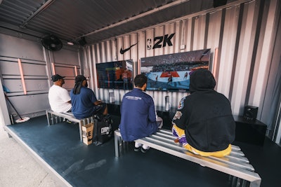 Surrounding the court, attendees explored a Nike Styling Zone, interactive gaming, exclusive retail, and a larger-than-life tunnel moment built into the seating structure.