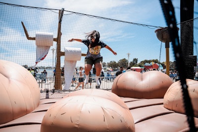 The activation included standout installations like the Rick and Morty Buttworld Bounce House, an adopt-a-cuy station with plush giveaways, and a SMILING FRIENDS break room replica. Nightly DJ sets, photo ops, and the DIRECTV Face Painting Zone kept guests entertained from day to night—no badge required.